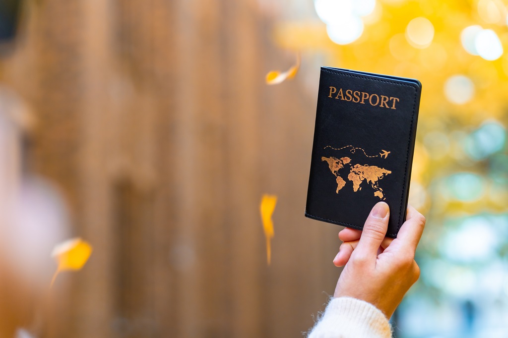 Hand holding passport outdoors symbolizing passport validity requirements for international travel