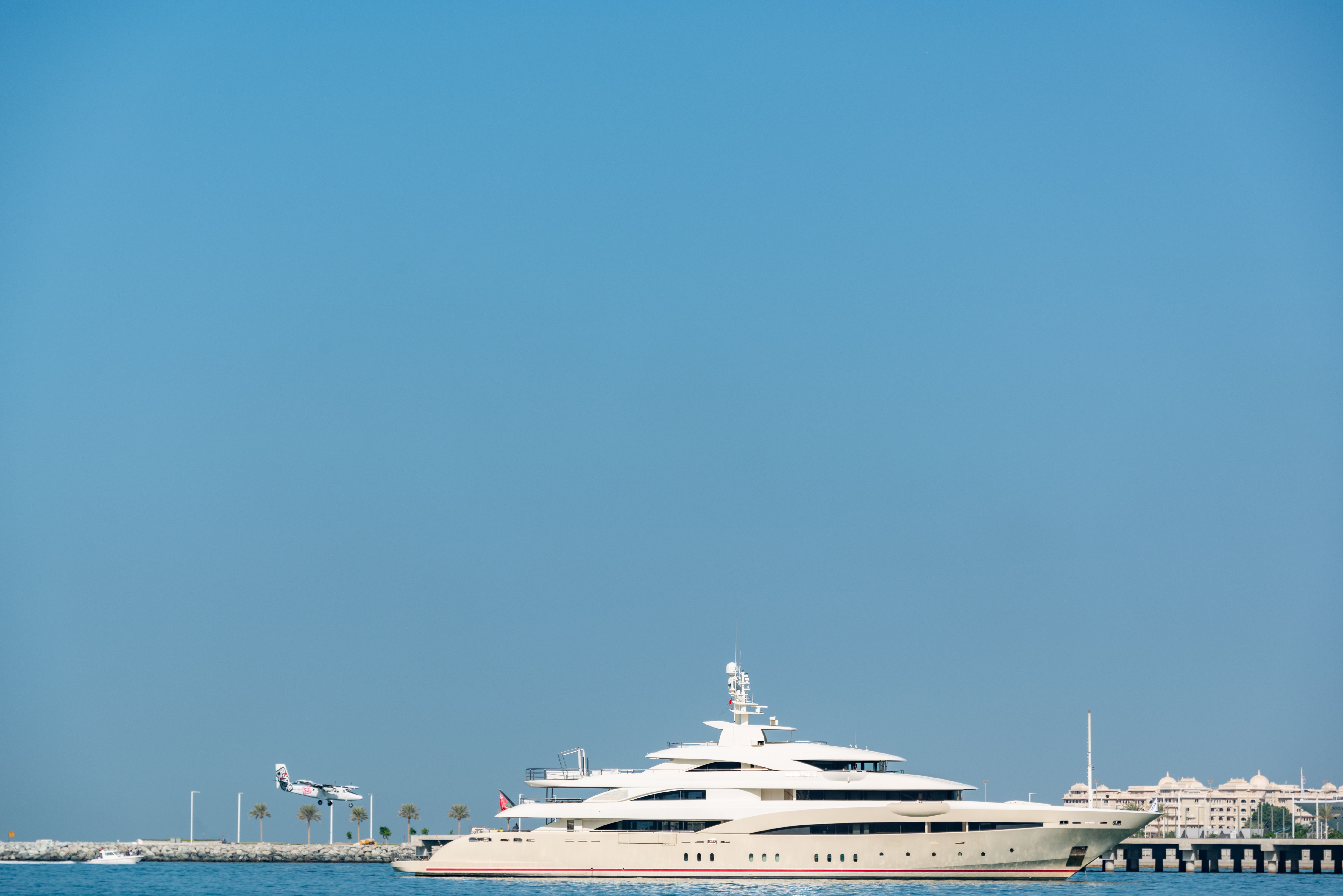 Luxury yacht cruising across open water, illustrating private charter travel for VIP clients.